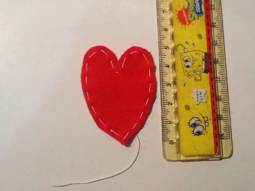 Sew around the edges using white thread and a needle. This picture shows how big my shape was, but ofcourse your card may not be the same size as mine. The hand stitching doesn't have to be perfect.