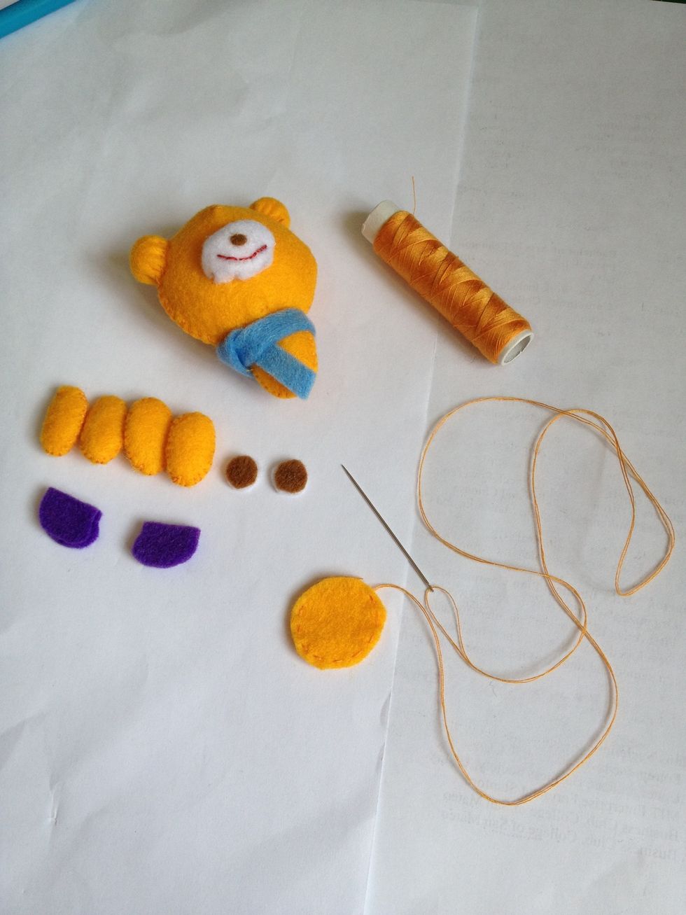 Sew bear's head, arms, legs and boots with overcast stitches. Then, using running stitches for ears and tail after tightening the thread (make them like a ball)! Attach other parts. Also, glue eyes.
