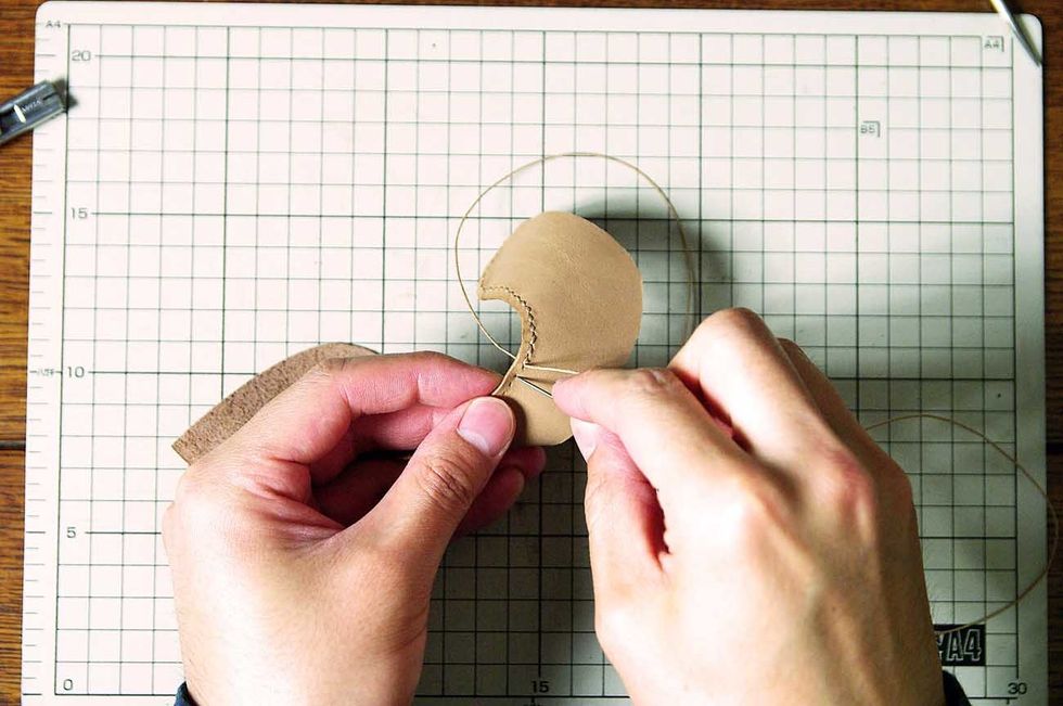 Sew it with the wax cord.