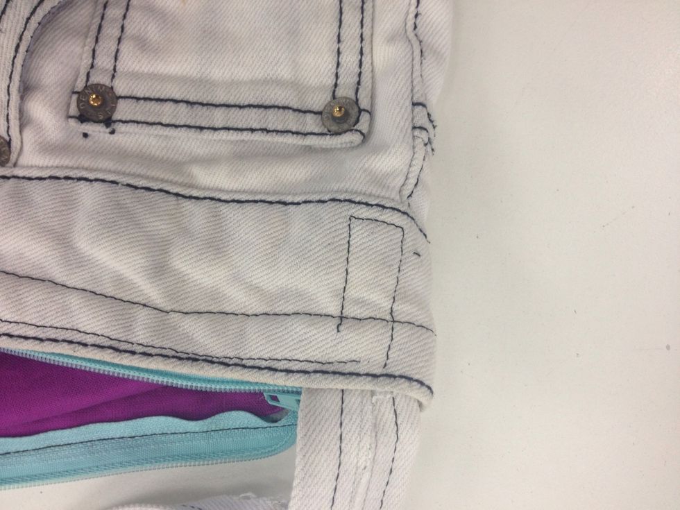 Sew one of the straps where the front hips sit with the sewing machine in a square pattern