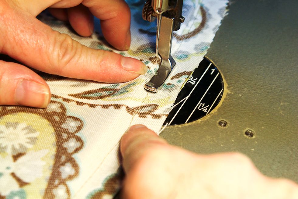 Sew the cushion back to the cushion front.  Use the previous stitch line where we just applied the piping as a guide.  Use a regular zipper foot to stitch close to the piping.