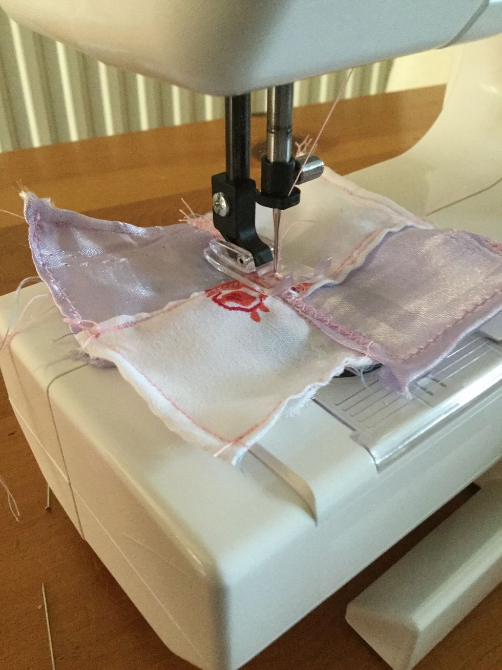 Sew the four pieces of material together with a zig-zag stitch. If you have it then a H or G stitch for decoration