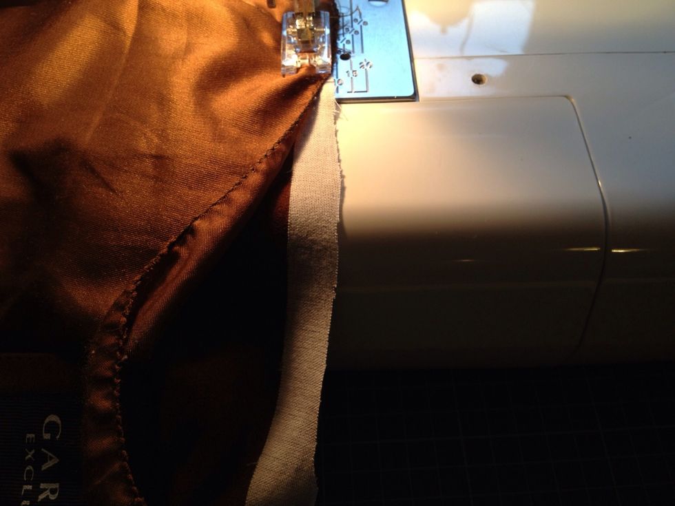 Sew the lining on to the suede bag along side the top.