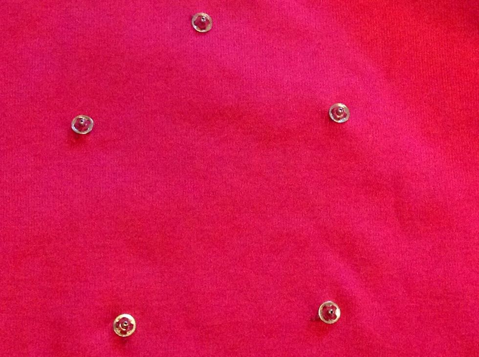 Sew the other half of the pressure button onto a T-shirt, making sure they are placed the right way to fit the half you placed on the figures. I used five, arranged in a circle.