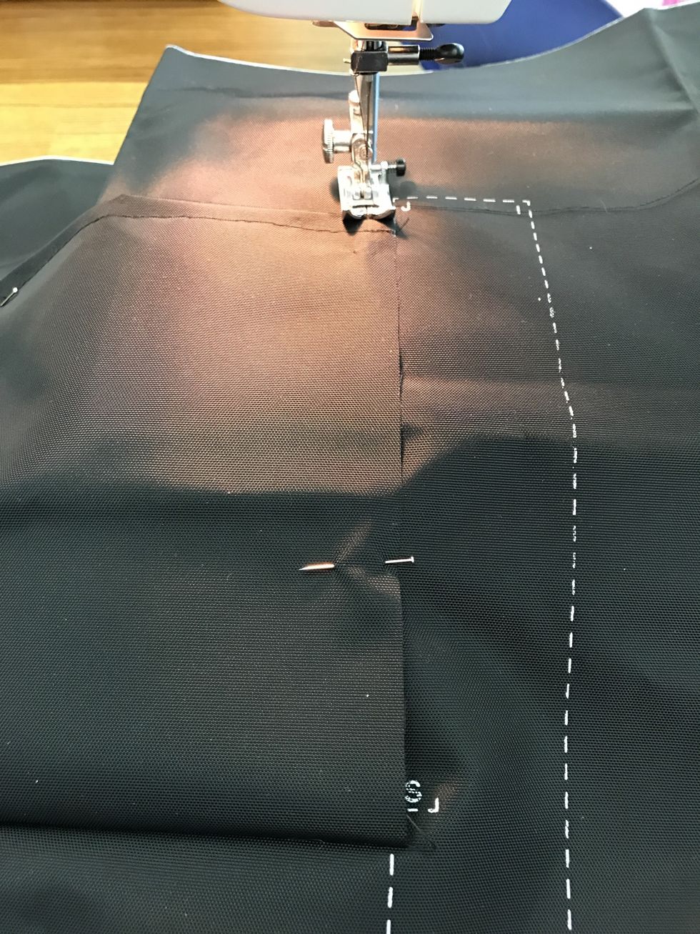 Sew the right side of the pocket at 3/8" (line up edge with right side of presser foot) and back stitch at the top of the pocket (near the J)