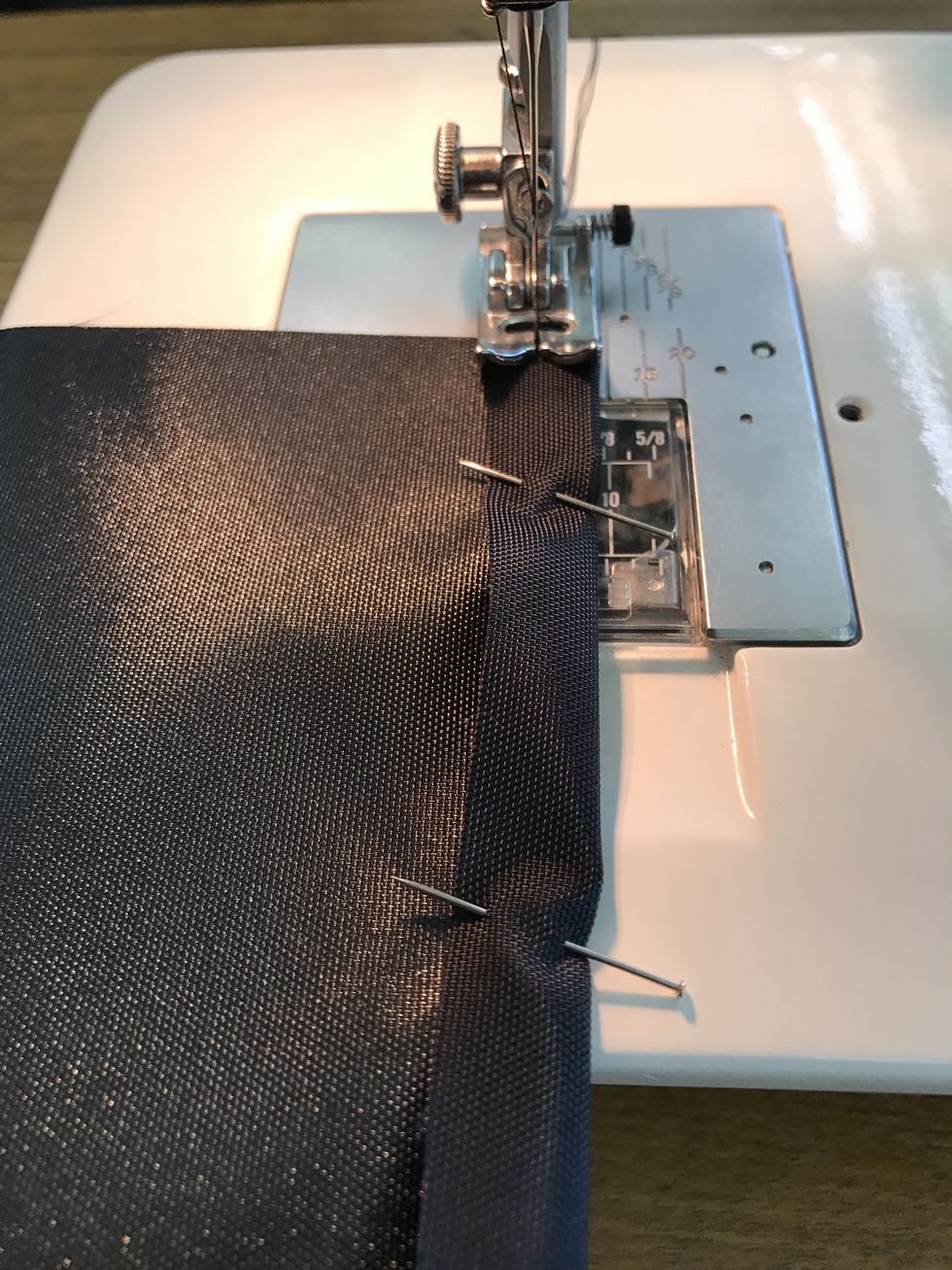 Sew the top of the pocket at 3/8" (line up fold with right side of presses foot) and back stitch at top and bottom.