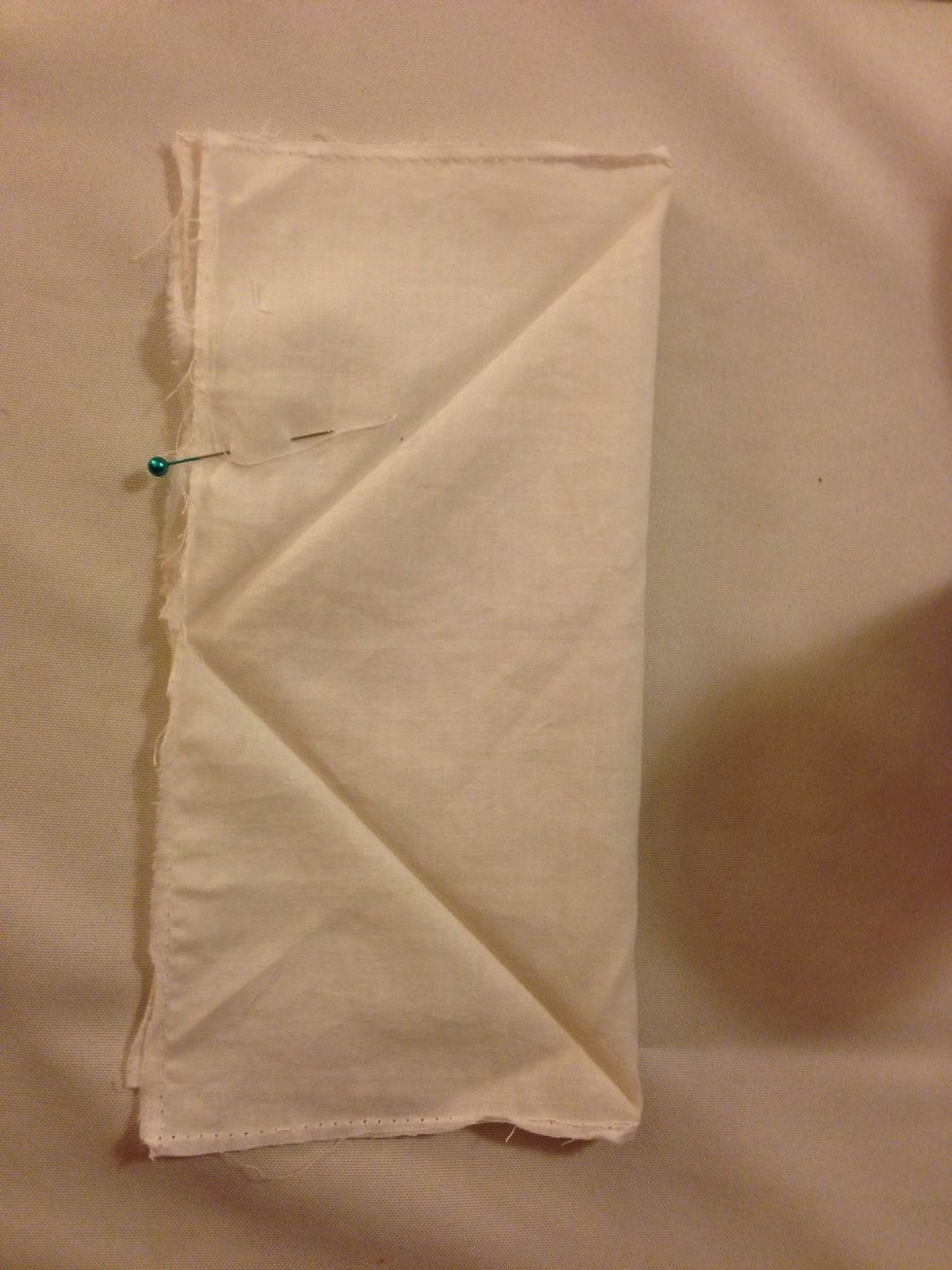 Sew up one side using your sewing machine. The turn the fabric and sew up the other side about three-fourths of the way up. Turn your fabric right side up and finish sewing.