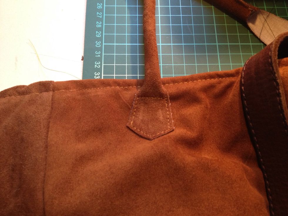 Sewed on the handle straps on the outside of the tote.