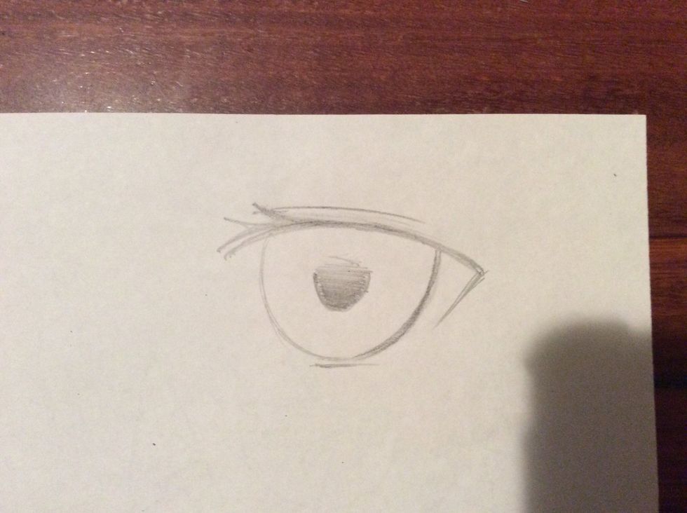 Shade from the bottom of the small near-circle, starting dark and growing lighter as you go upwards. Slowly release the pressure on the pencil to shade, and blue with an eraser if needed.