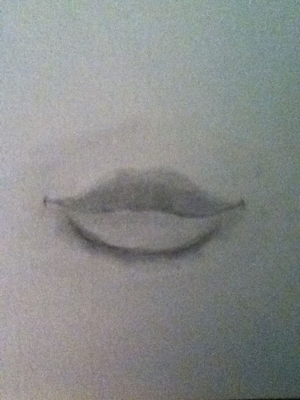 Shade the lips, upper lips are darker than the lower lips due to light since the lower comes out more and is larger. Now shade dark because erasing comes later. Shade underneath as well.