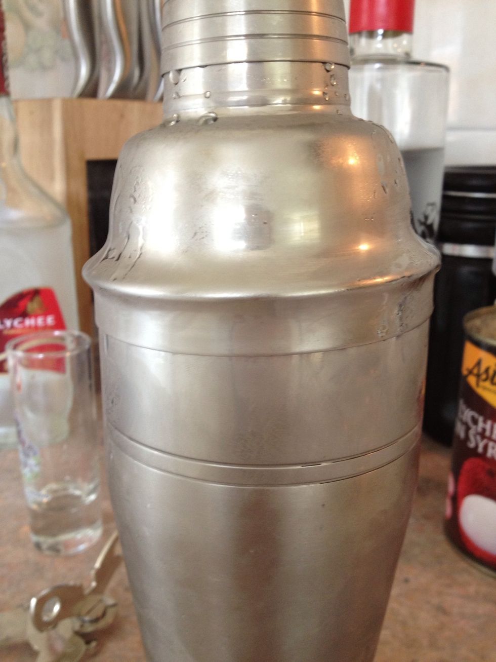 Shake the ice, booze and lychee juice.