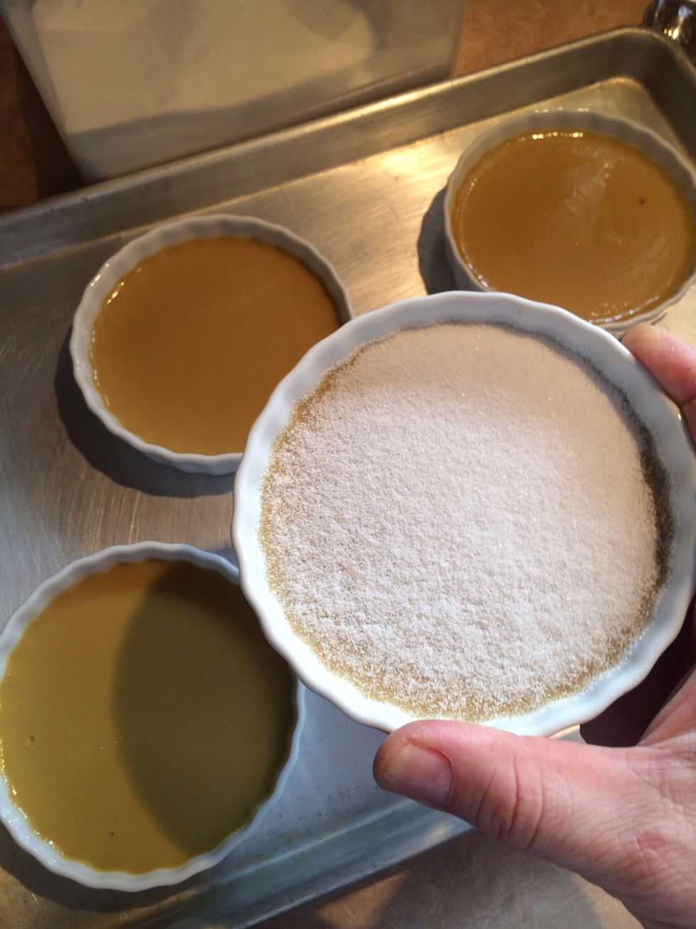 Shake the sugar to coat the entire top of each custard.