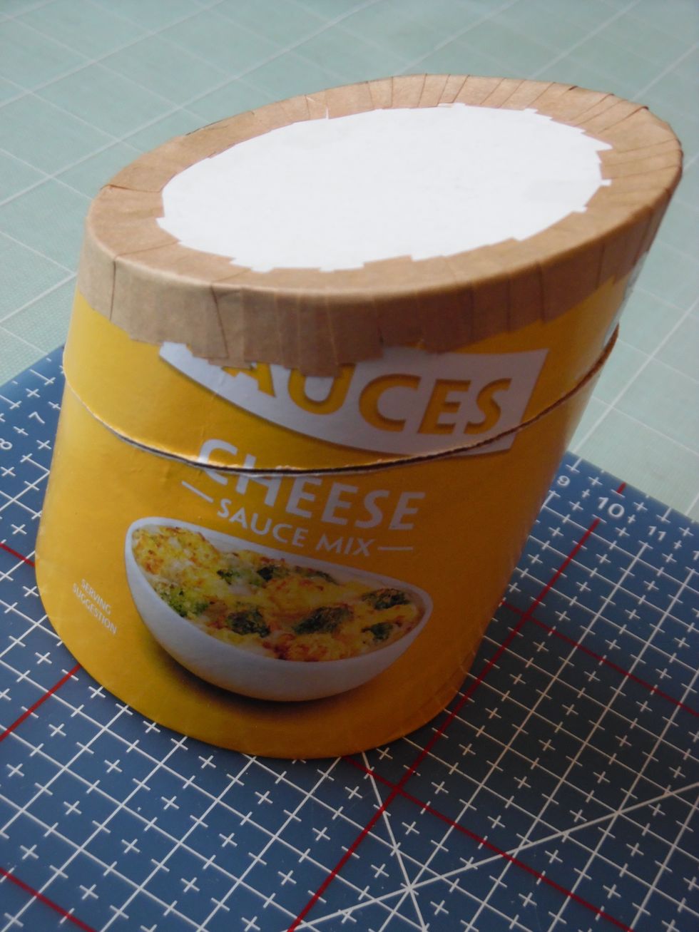 Shame to waste all that space. What if we cut off the lid and make a fancy box? Time to saw off the top with a fine blade hacksaw. Match the saw line to the top of the hat.