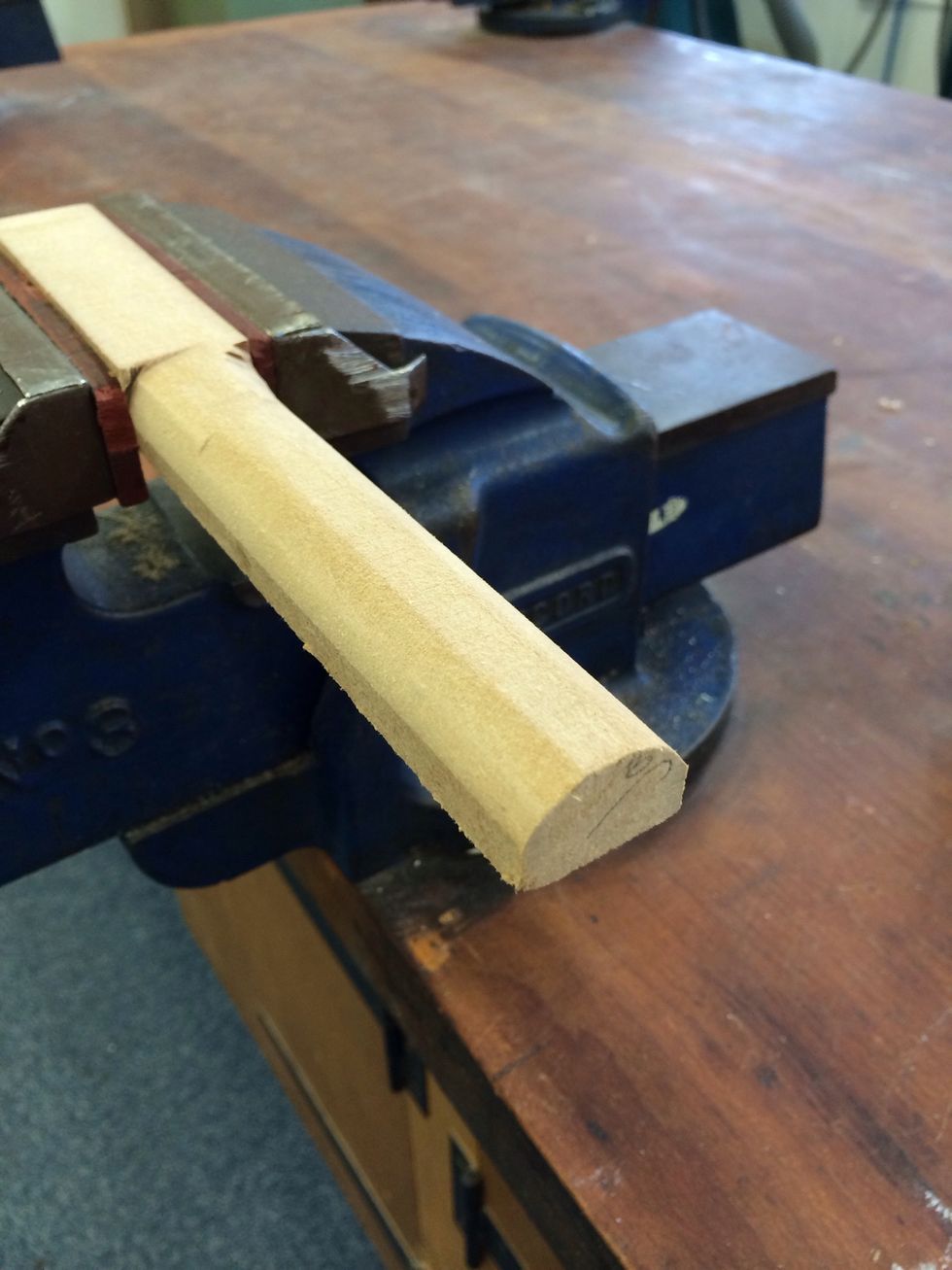 Shape an off-cut scrap piece of timber or MDF to place the can on.  This provides a surface to press against in the coming steps.