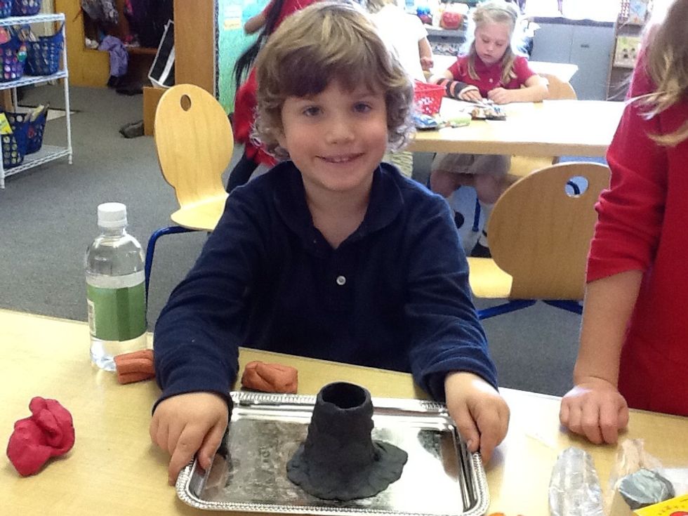 Shape clay into a volcano.