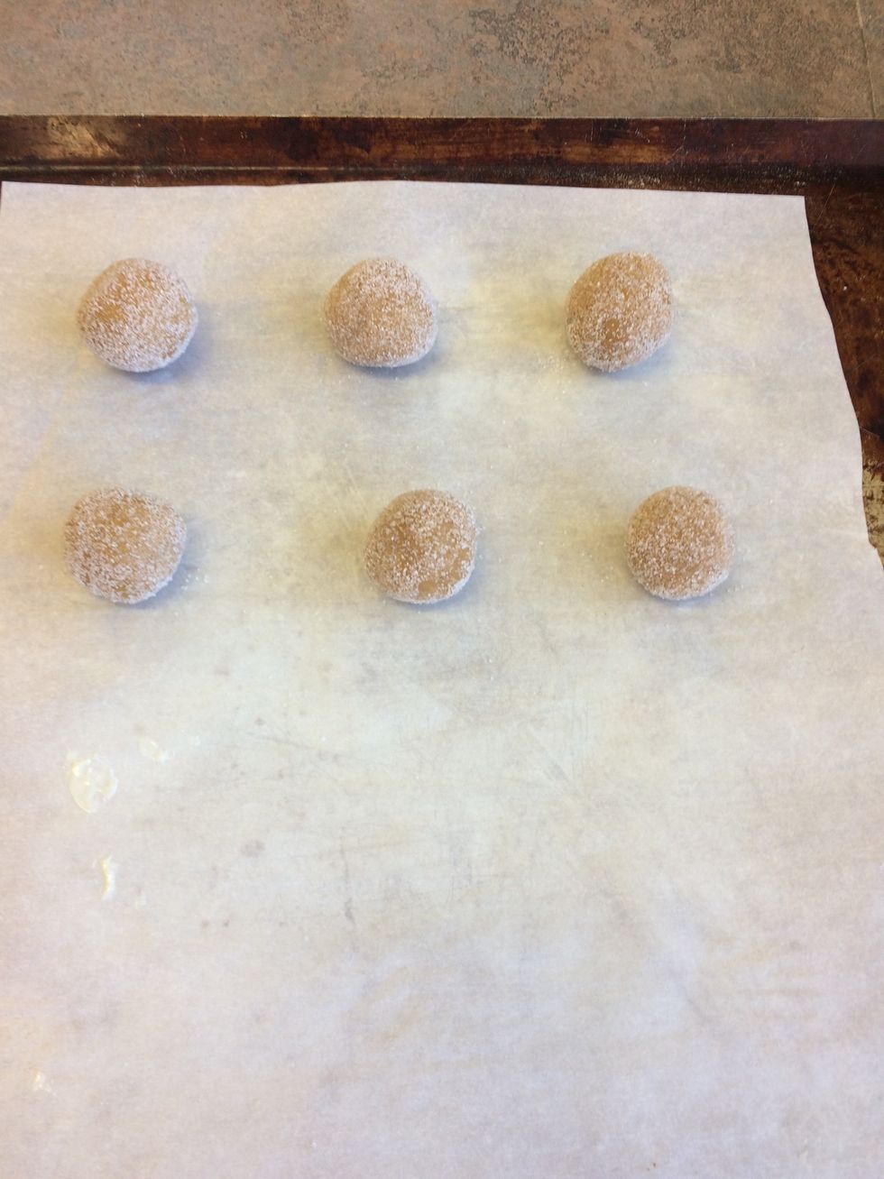 Shape dough into one inch balls roll in granulated sugar. place two inches apart on parchment lined baking sheet