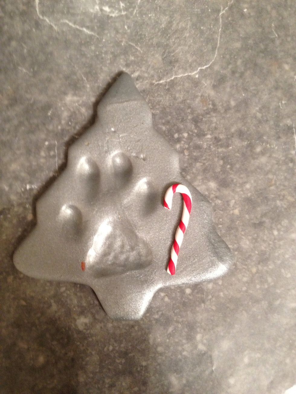 Shape into a candy cane, and cut off the tips. Put it on the ornament to determine placement and size.