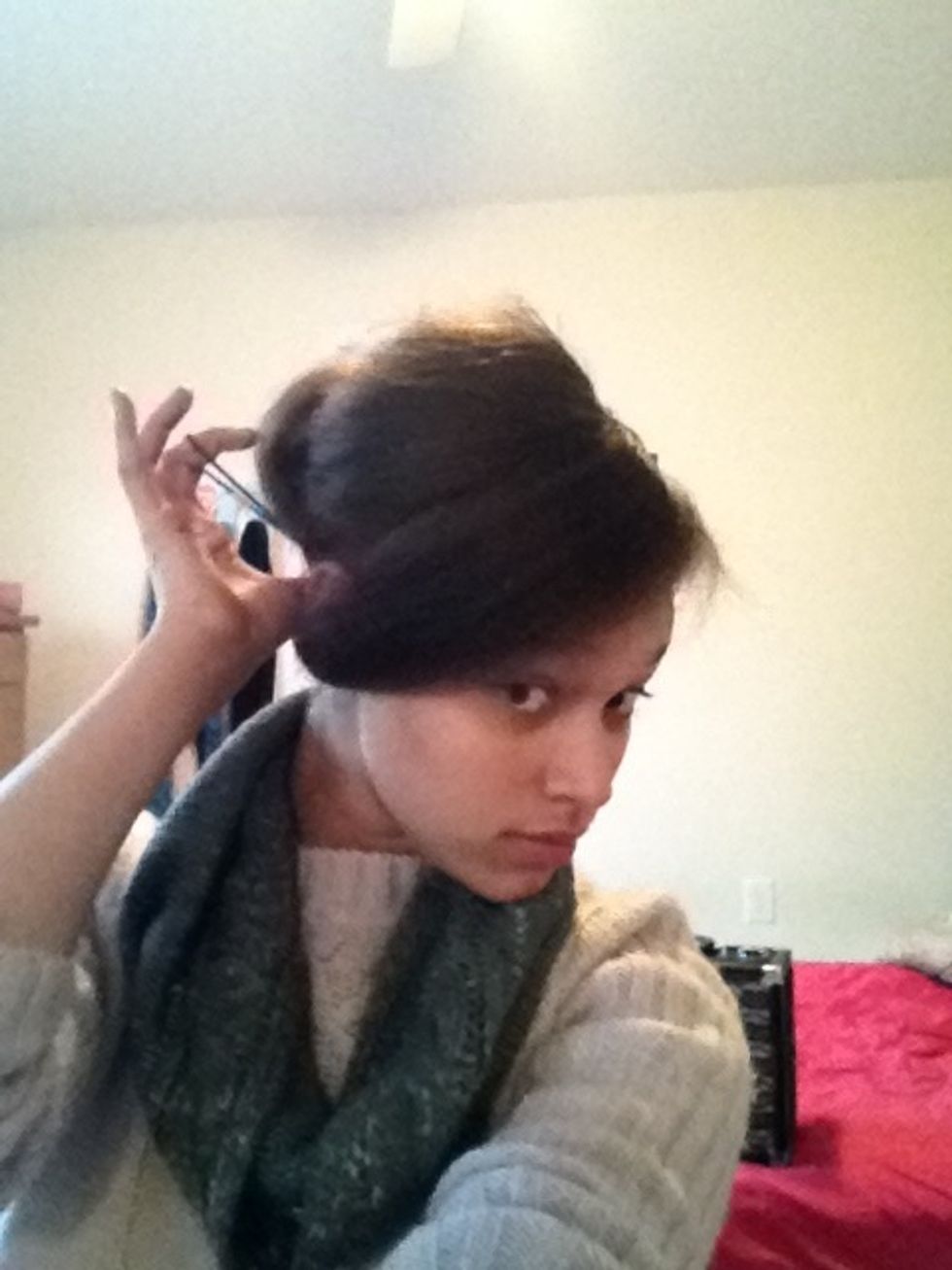 Shape the bottom of the ponytails into a bun and loop a ponytail holder around them