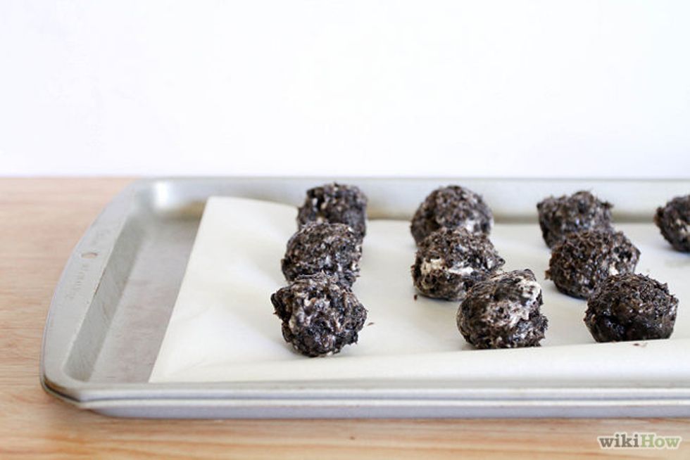 Shape the mixture into 42 1-inch (2.5cm) balls. Place each ball onto a baking sheet covered in wax paper.