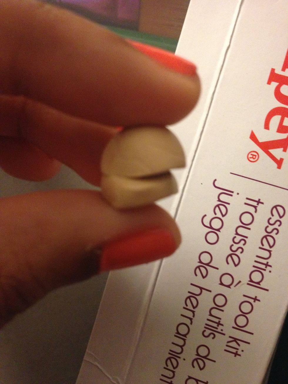 Shape the tan clay so half of it has a rounder top and cut it in half.
