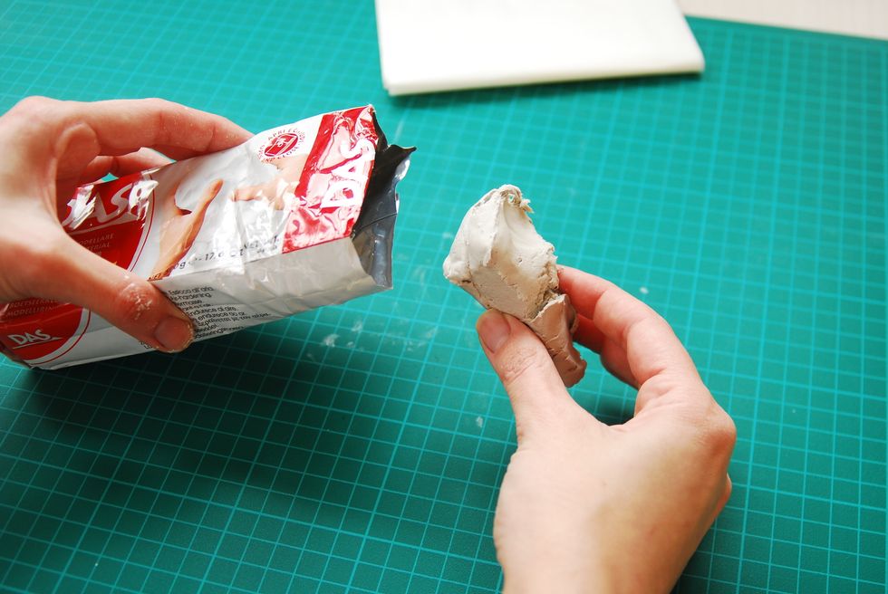 Shaw piece of clay the size of the apricot and soft it by kneading.