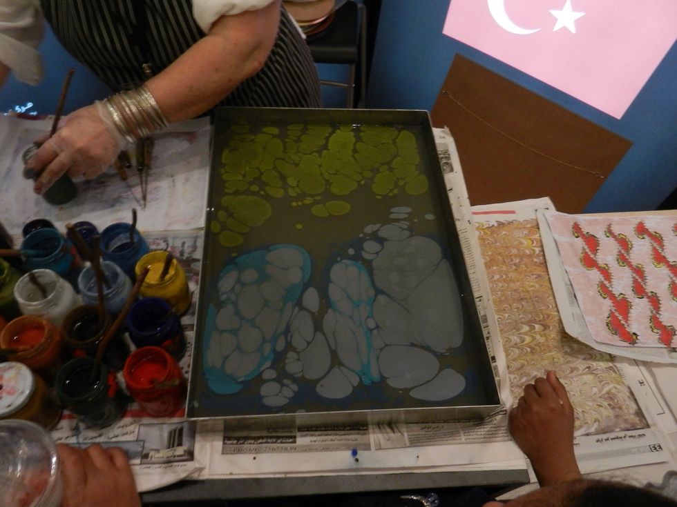 She has added blue and green. Note how she's added white paint inside the blue.