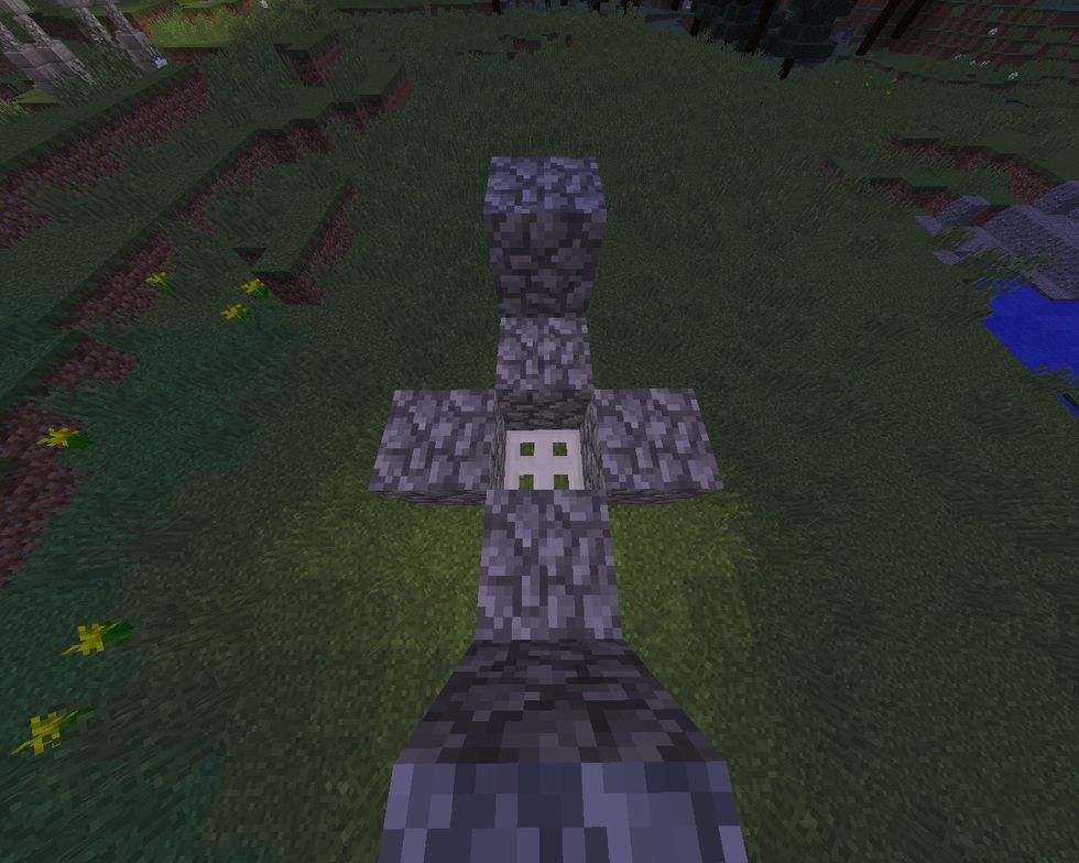 Shift click on redstone torch to place a iron trapdoor there