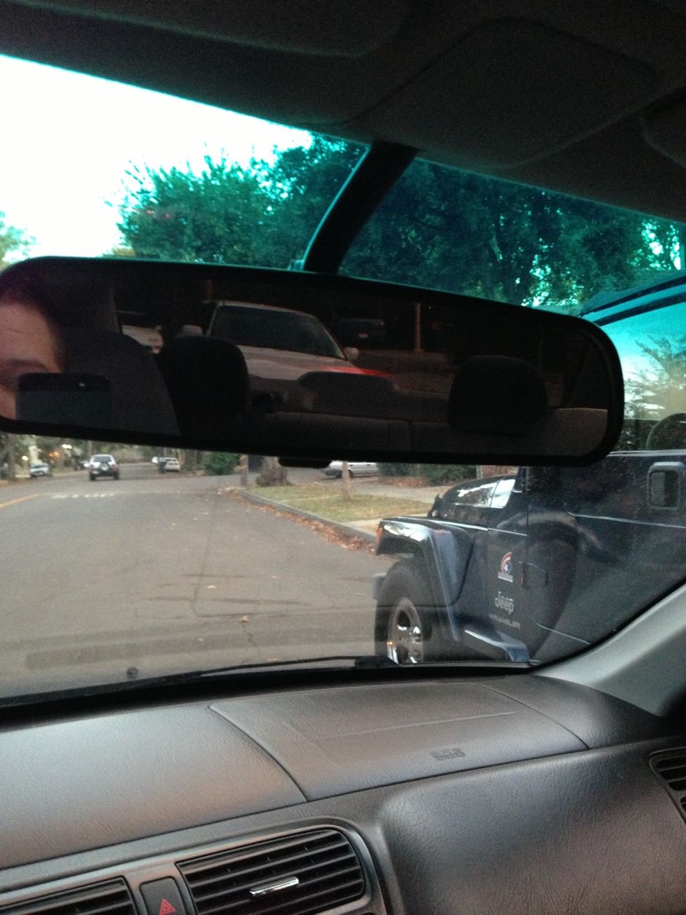 Shift into reverse, turn the wheel almost all the way to the right, then advance backward until your third brake light is lined up with the cars right headlight. See rearview mirror.