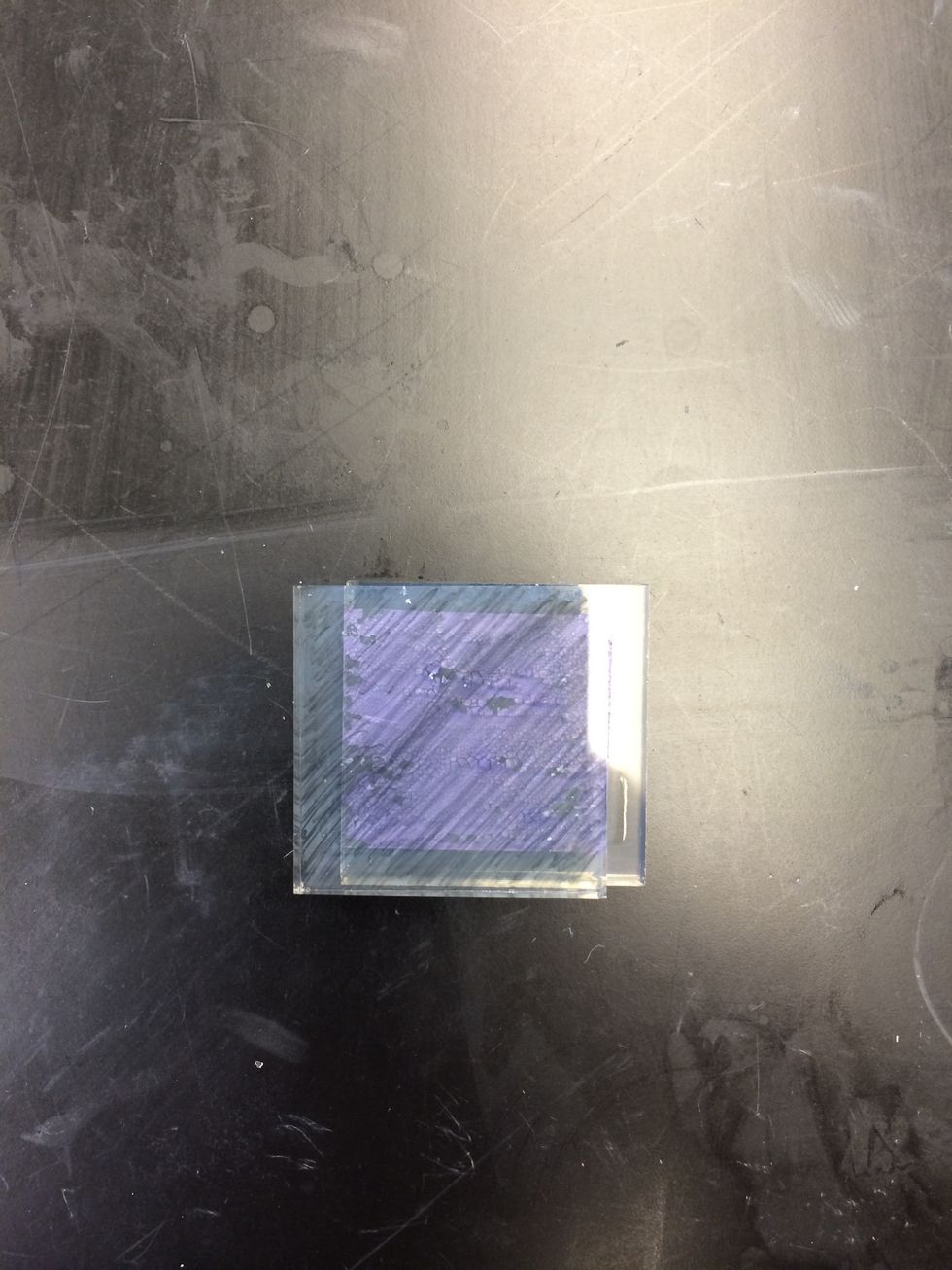 Shift the plates so that the uncoated edge of the TiO2 plate is exposed. Place two binder clips on the edges to hold the plates together.