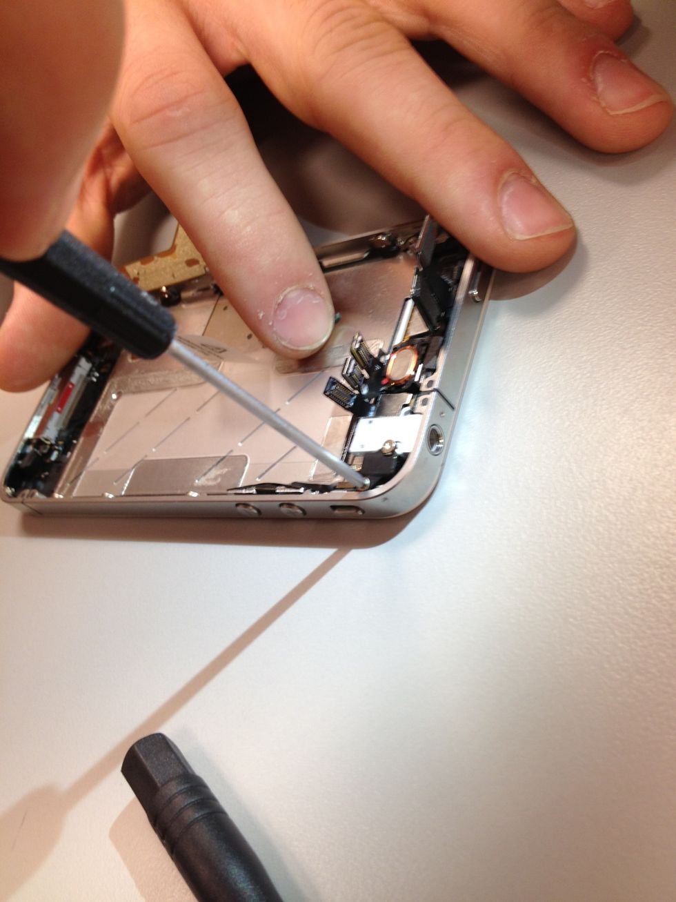 Shifting back to the top, on the opposite side of the camera you will find the vibrator. Two screws keep it in place, make sure you match them up correctly with your ScrewMat after removing.