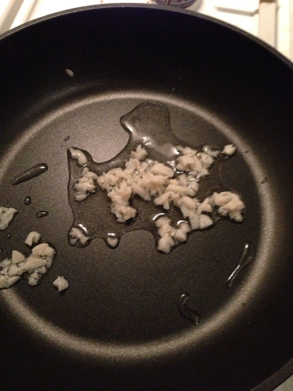 Shimmer garlic in your shiny new frying pan :). Wait for the oil to get hot before adding the garlic.. I used 2 cloves, but if you need to go somewhere after dinner take 1. Be careful not to burn!!