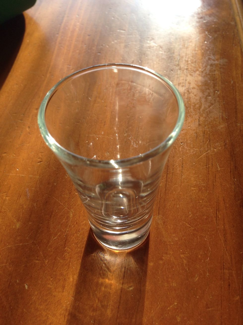 Shot glass or any small vessel that can hold water can be used.