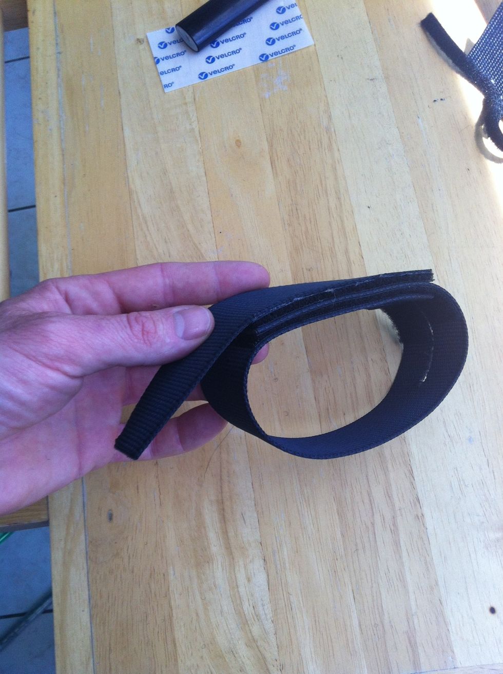 Should stick together like this. The loose end needs to be attached. (by my pinkie)