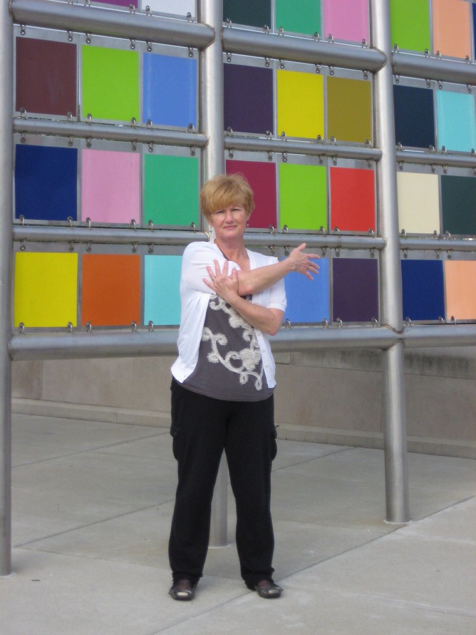 Shoulder stretch \u2013 pull one arm across body at shoulder level. Use other hand to pull arm toward body.