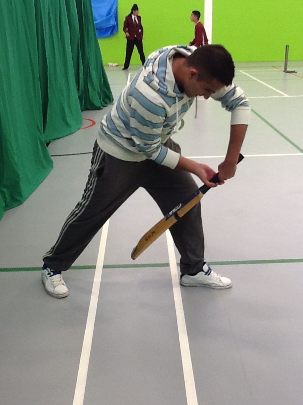 Shoulders rotate vertically to begin downswing, bat decelerates to contact