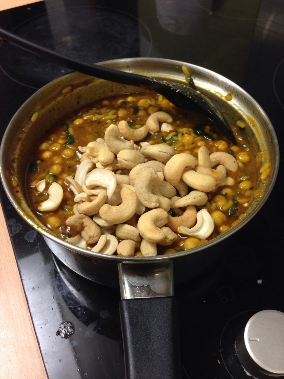 Shove in a handful of cashew nuts and mix in.