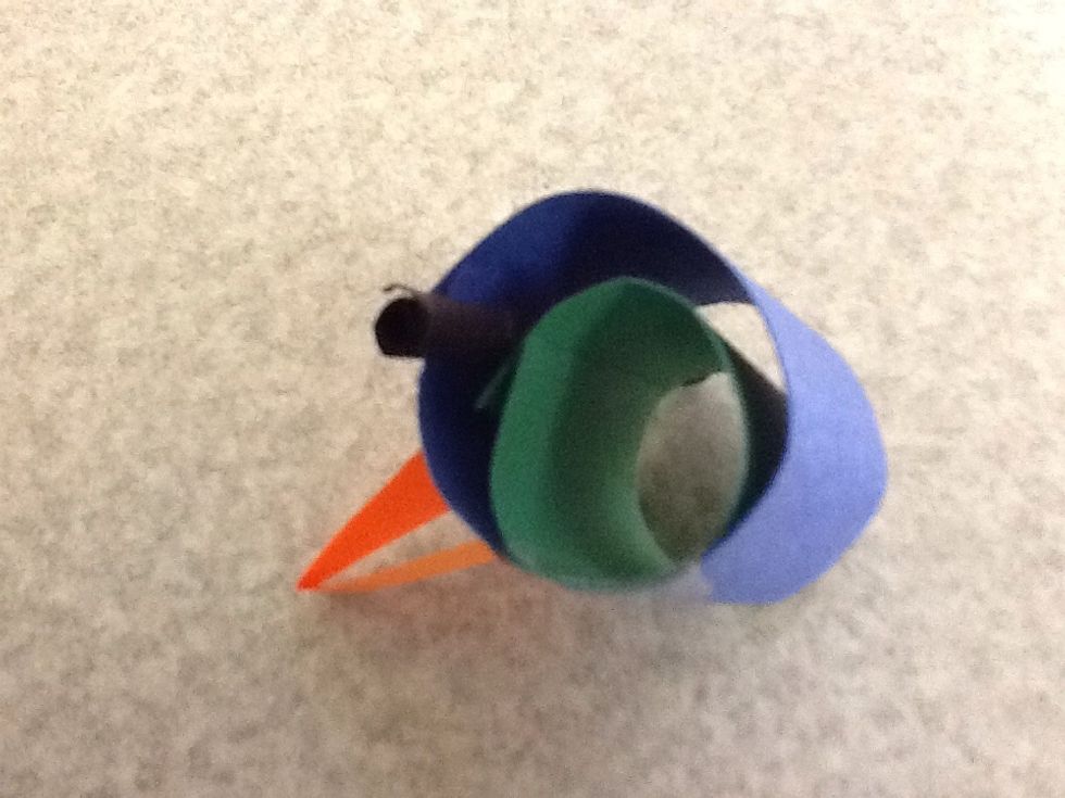 Shove the black piece in between the two head circles with a tape pocket on it