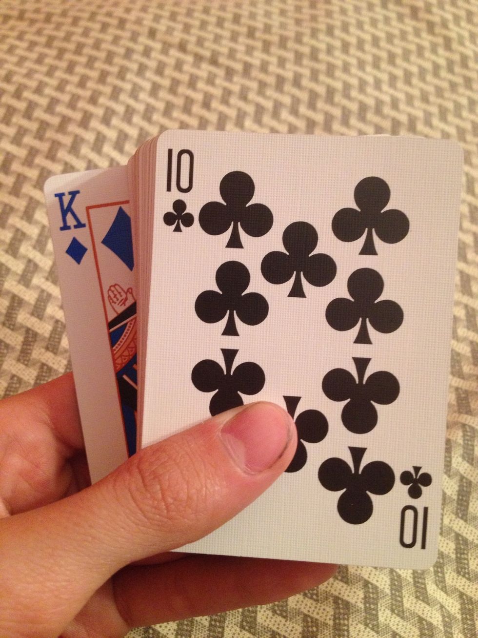 Show that their card is not on the top or the bottom. (Their card is second from the top)