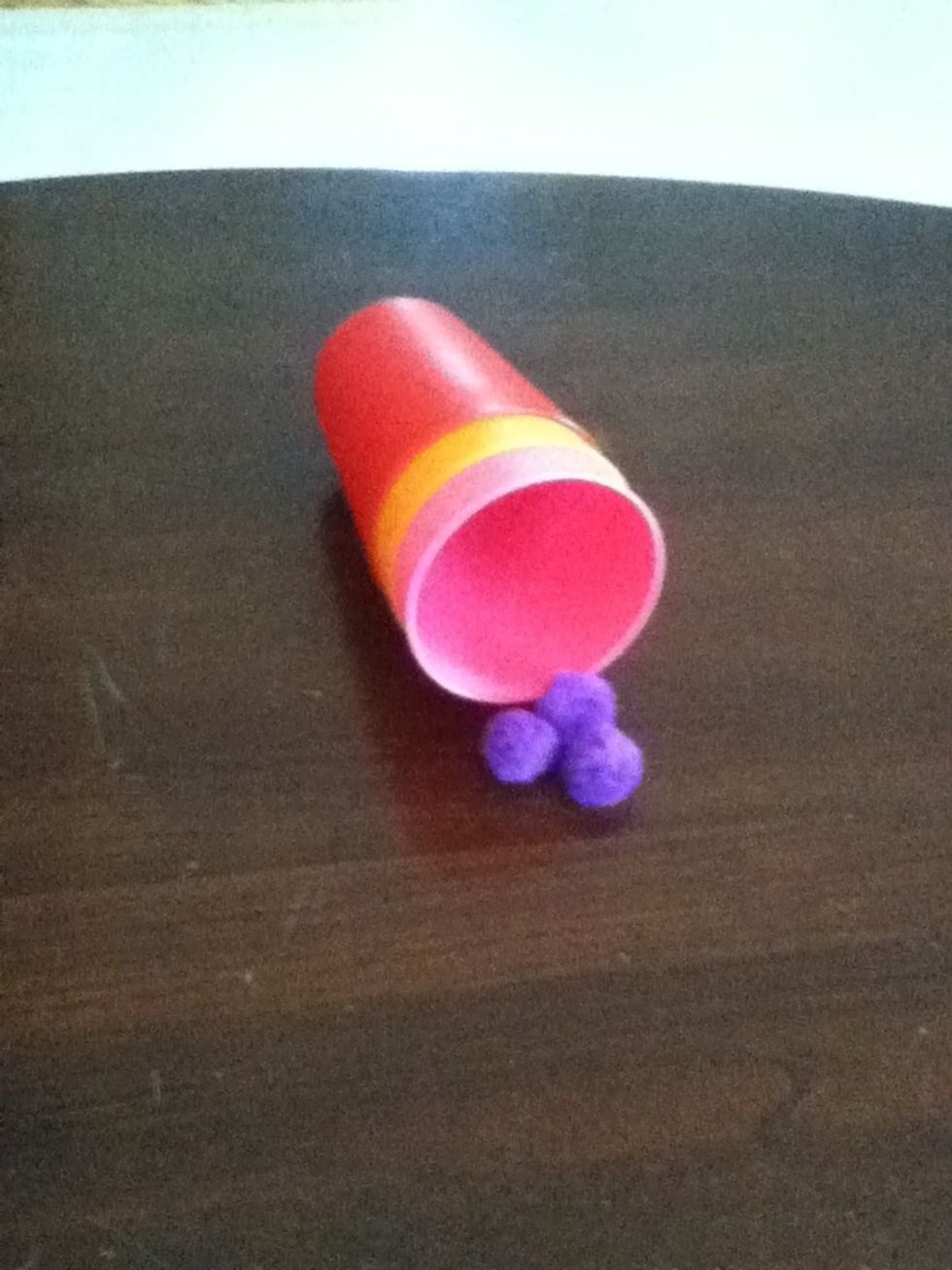 Show the audience the inside of the cup and point to the balls