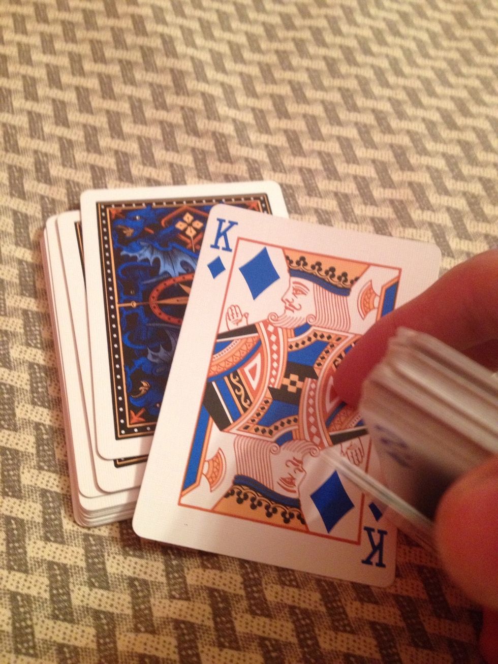 Show the first card from the pile without the pinky break, when they say "that's it", say that you don't believe them. Then put that card on the table face down.