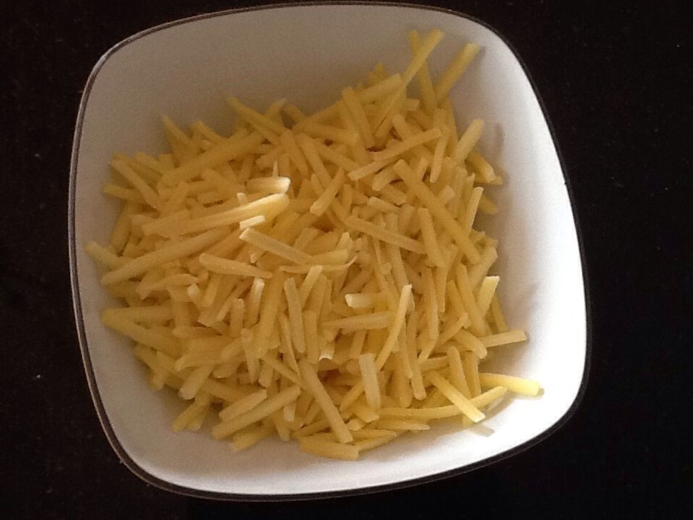 Shred enough low-fat cheese into a bowl to serve four people.