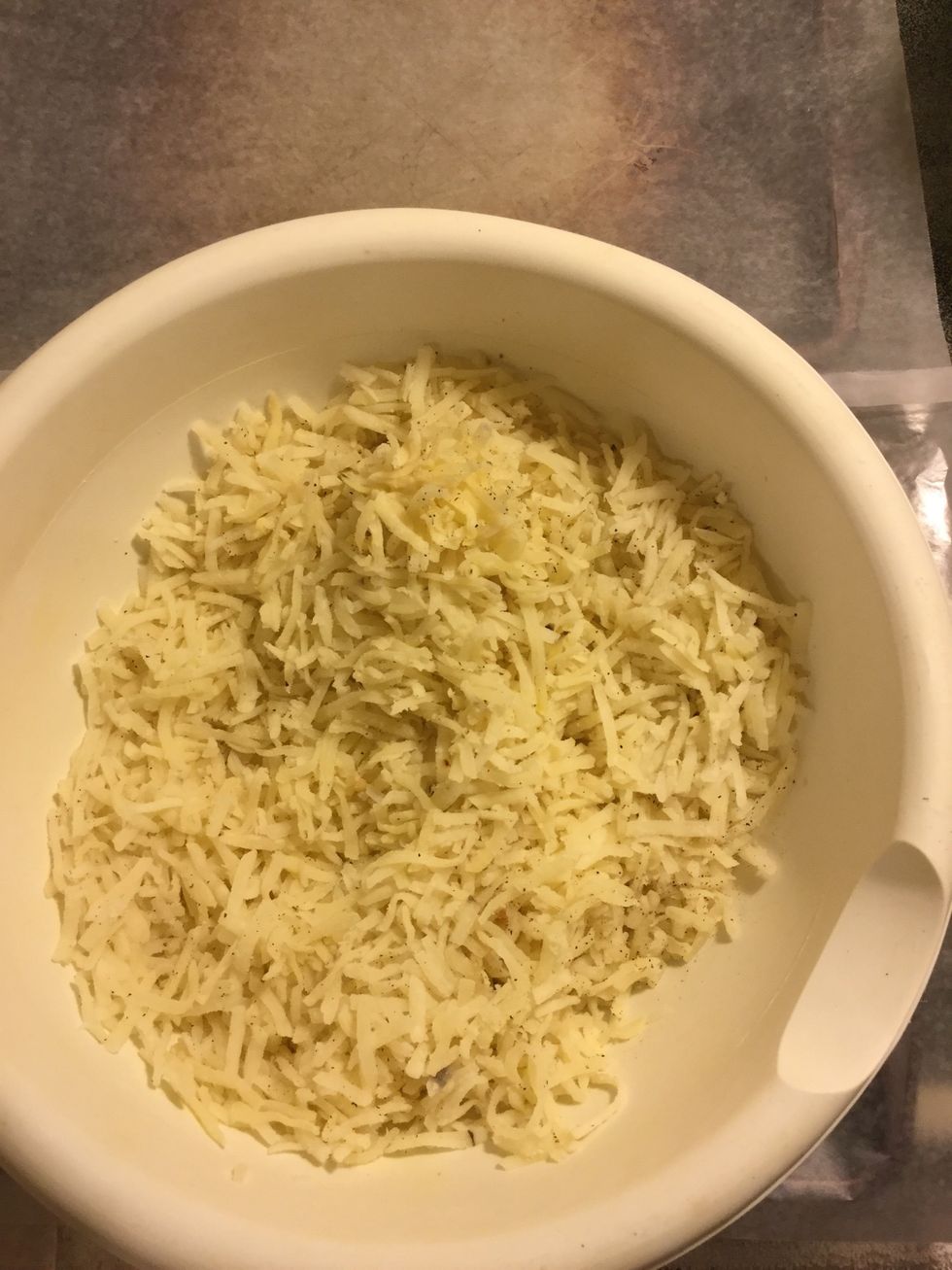Shred potatoes and put in bowl.