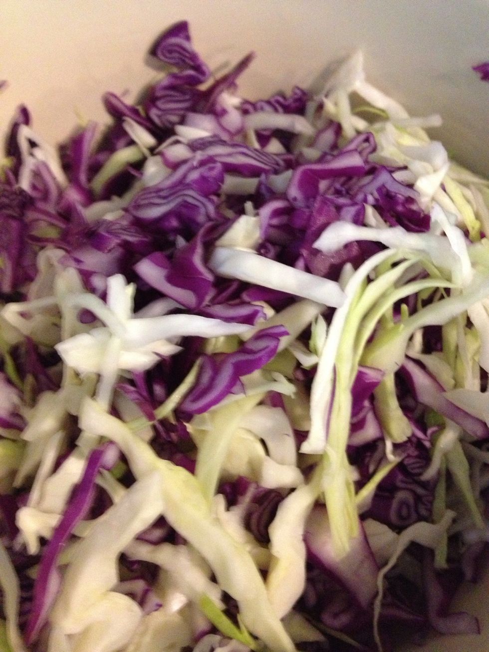 Shred the cabbages and mix them together in a large bowl