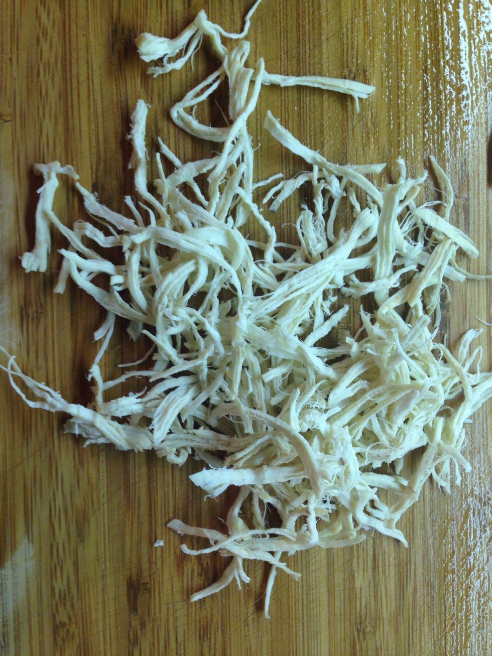 Shred the chicken into thin strips by pulling it apart by hand.