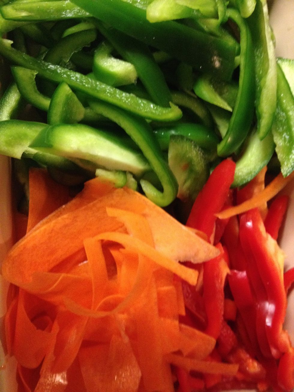 Shred your onion, peppers and carrots into small strips