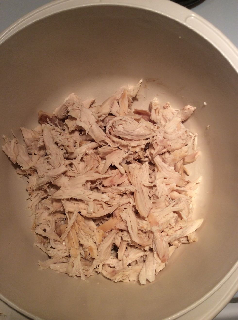 Shred your rotisserie chicken and put it into a medium bowl.