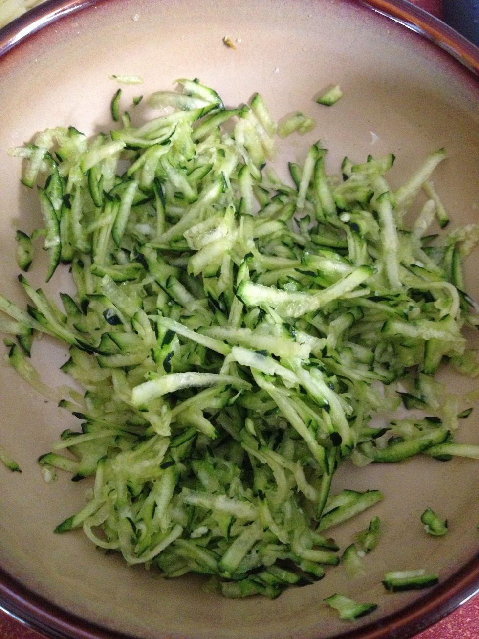 Shred zucchini, then sprinkle with a pinch of salt and toss. This will help draw out the extra moisture.