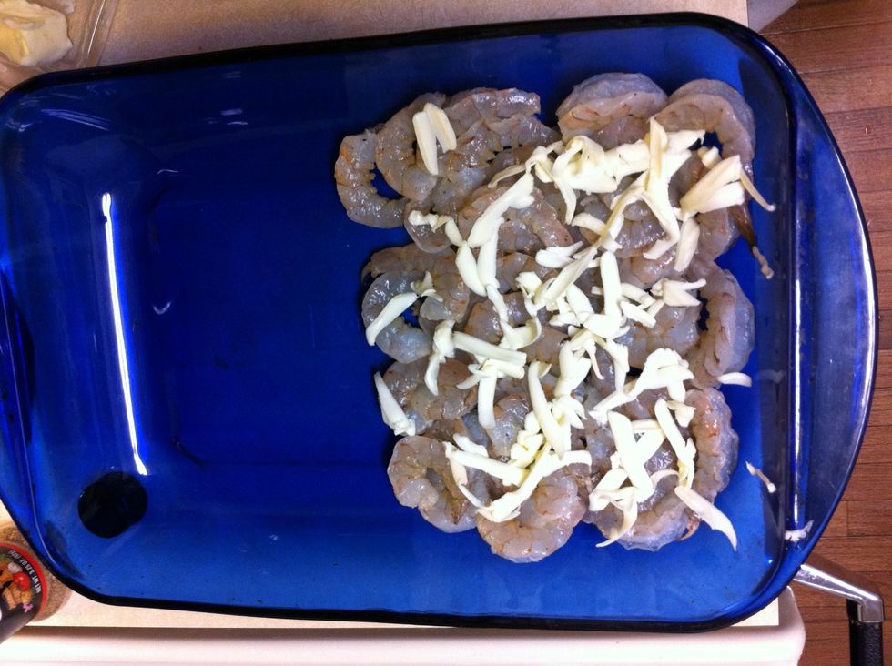 Shrimp spread out on half of baking. Cover with grated butter.
