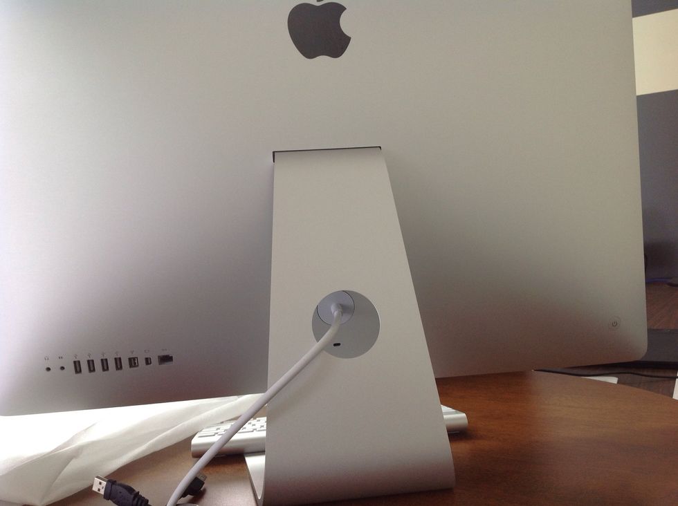 Shut computer off and remove all USB peripherals and unplug white power cord from back of iMac. (I am demonstrating on a mid-2010 model iMac 27". Steps may be different on older or newer models.)