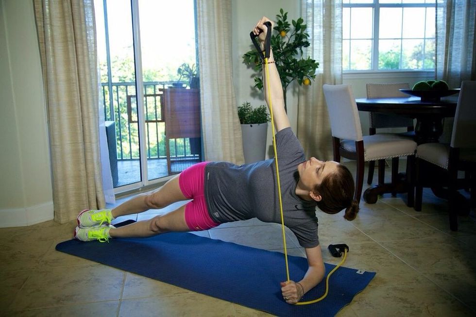 Side Plank Lift Part II: be sure to keep the shoulder back and the elbow up at all times. Then, slowly lift the free arm straight into the air. Continue for 1-minute, then alternate sides.